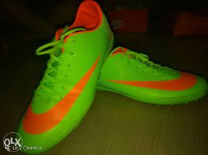 Green-and-orange Nike Cleats
