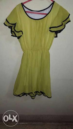 Neon green chiffon dress with black border,