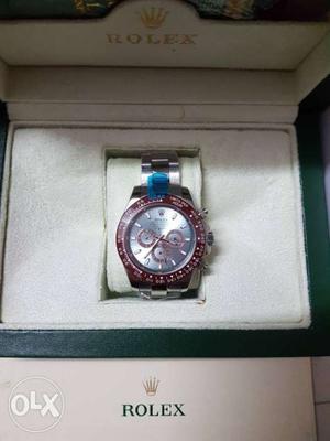 Round Silver And Red Rolex Chronograph Watch With Silver