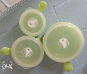 Three Green And White Plastic Canisters