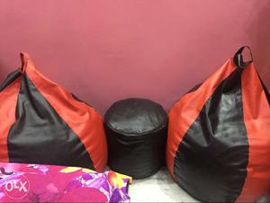 Two Black-and-orange And Black Leather Bean Bags