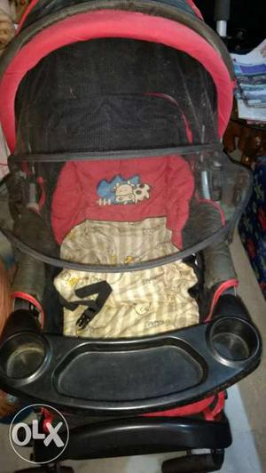 Baby's Red And Black Stroller With Tray