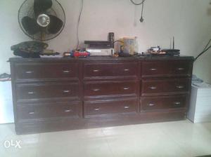 Brown Wooden Dresser With Black Desk Fan
