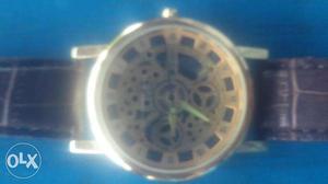It is round dial brown leather strap quartz watch