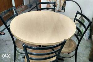 Round Beige Wooden Table With Four Black And Beige Metal
