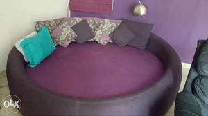 Round Black Frame Purple Padded Bed With Throw Pillows