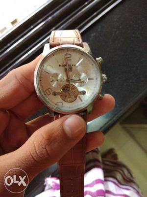 Round Silver Chronograph Watch With Brown Strap