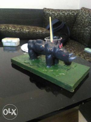 This is a rhino sculpture made of clay you can