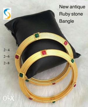Two Gold With Red And Green Gemstone Bangles