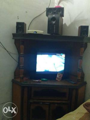 Flat Screen Television And Brown Wooden TV Hutch