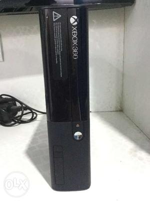 Xbox 360 E with two wireless controllers.