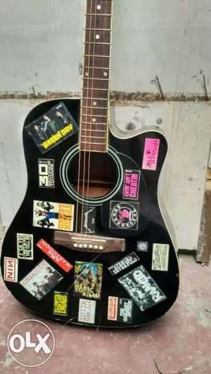Black Acoustic Guitar With Stickers