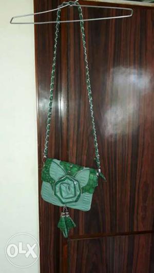 Green sling bag with 3 pockets not used more than