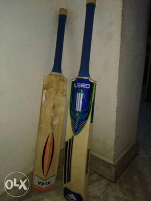 Two Brown And Blue Cricket Bats