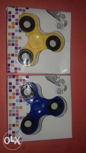 Two Yellow And Blue Fidget Hand Spinners In Box