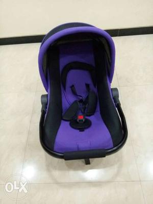 Baby's Purple And Black Car Seat Carrier