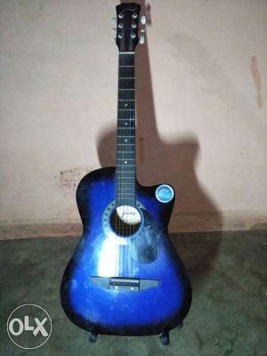Blue And Black Acoustic Guitar With Black Stand