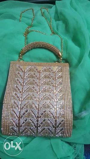 Design stoned purse in white n golden work
