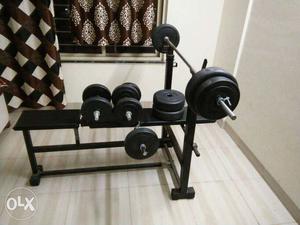 Gym equipment with bench press, dumbles, two