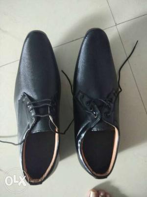 Pair Of Black Leather Wingtip Dress Shoes