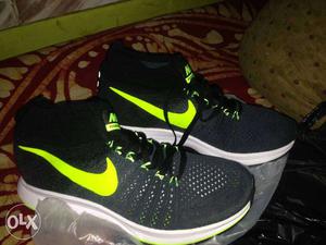 Pair Of Black-and-green Nike Athletic Shoes