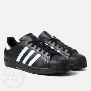 Pair Of Black-and-white Adidas Superstar Shoes