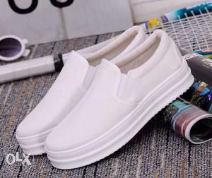 Pair Of White Slip On Shoes