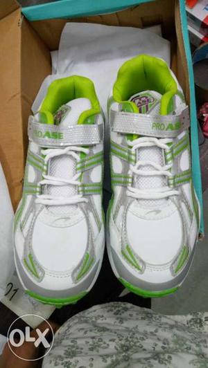 Pair Of White-and-green Sneakers In Box