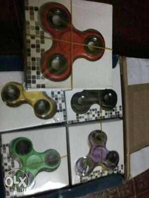 Red, Yellow, Black, Green, And Purple Fidget Spinners In