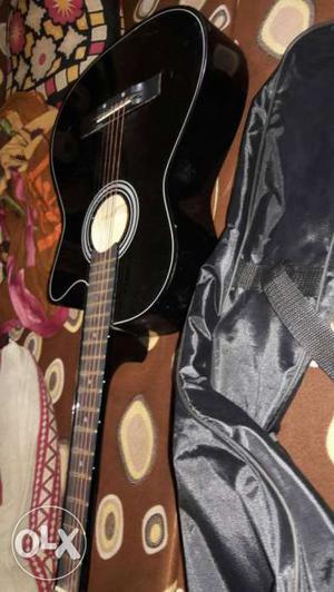 All new aqoustic guitar with extra strings, belt and coverat