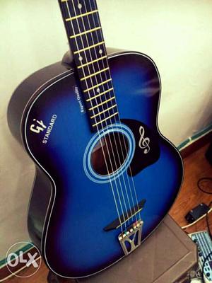 Blue and black acoustic guitar in half price,