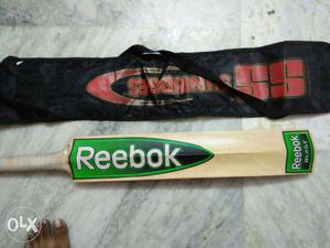 Brown, Green, And White Reebok Cricket Bat With Bag