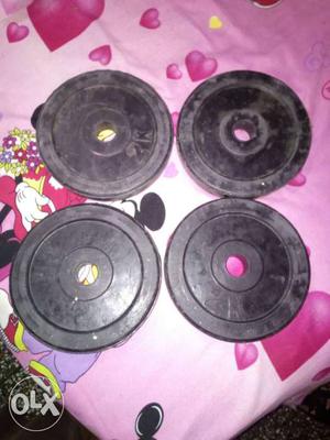 Four Black Steel Barbell Plates