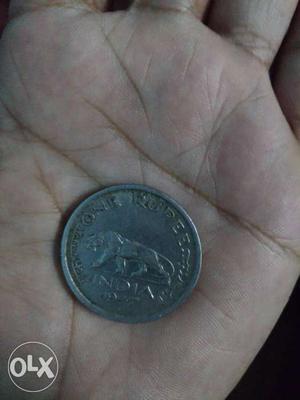 Its a silver indian coin of 1 Rupee Year 