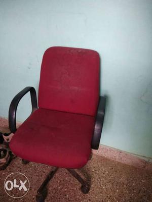 Black metal base with red padded office armchair in good
