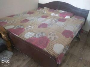 Brown Wooden Bed Frame With Rose Printed Bed Linen