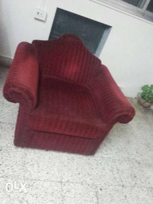 It's a maroune colour cloth cover sofa chair