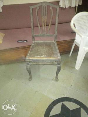 This is an old saag wood chair which has carved