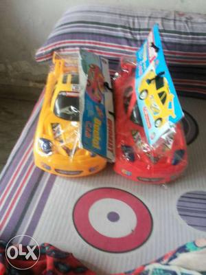 Two Yellow And Red Toy Cars