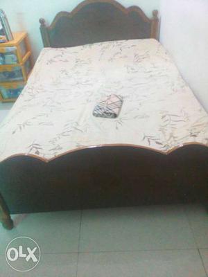 Brown Wooden Bed Framed With Mattress