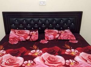 Tufted Black Leather Bed Headboard With Floral Bedding