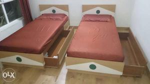 Two Brown Wooden Trundle Bed