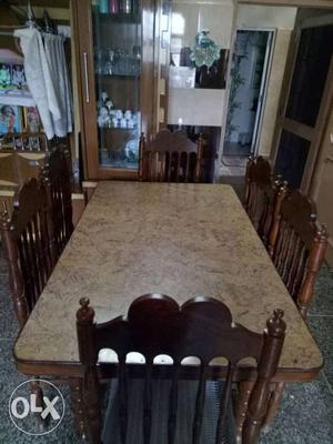 Rectangular Brown Wooden Table With Six Padded Seat Chairs