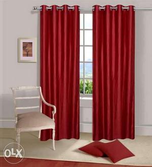 Red Window Curtain; White Wooden Framed Gray Padded Armchair