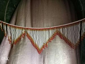 White, Red, And Gold Beaded Accessory
