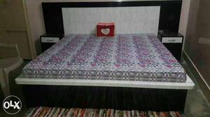 Black And Gray Wooden Bed With Gray-pink-red Floral Mattres