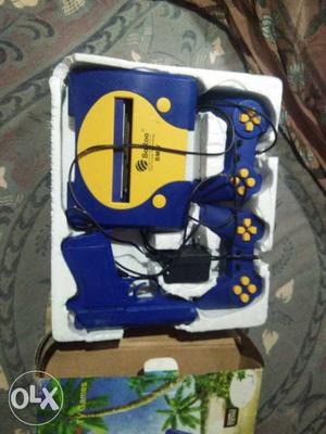Blue And Yellow Game Console And Controllers
