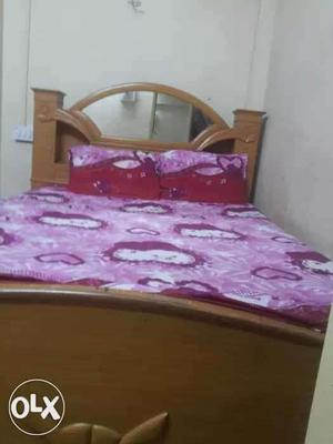 Brown Wooden Bed Frame With Maroon And White Mattresses