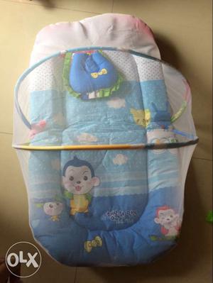 Baby's Blue, White, And Pink Sleeper With Net