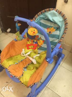 Baby's Purple, Teal, Orange And Yellow Bouncer Chair
